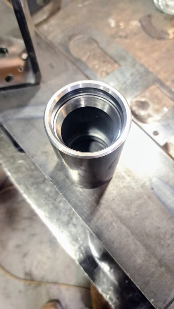 Close-up of a precision-machined metal sleeve with chamfered edges